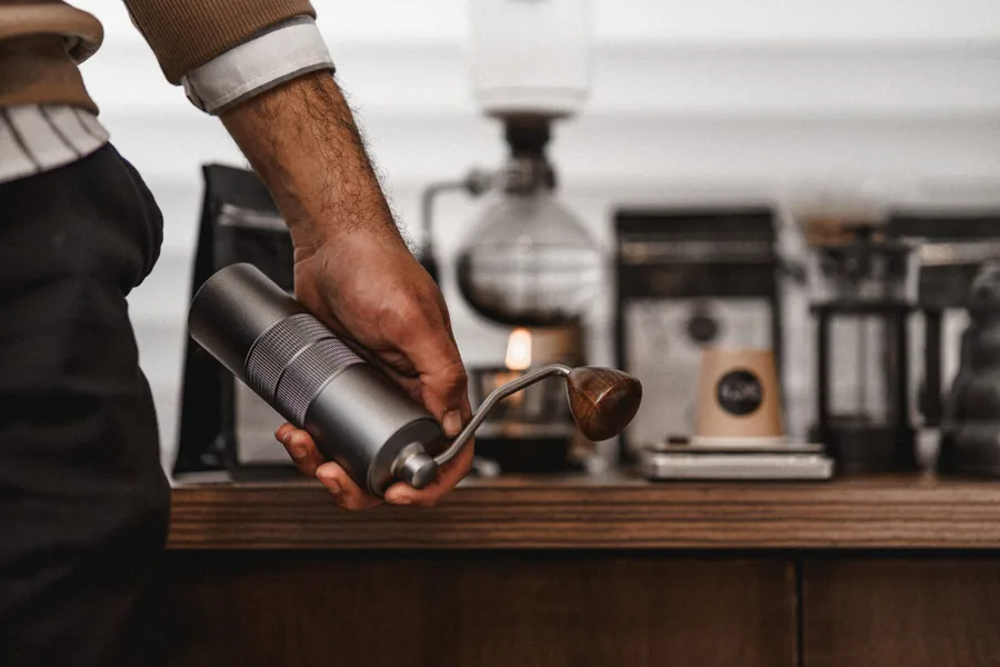 A coffee preparer using a hand grinder.